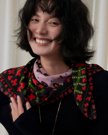 Woman wearing a crimson leopard floral mulberry silk scarf tied in a neat neck knot