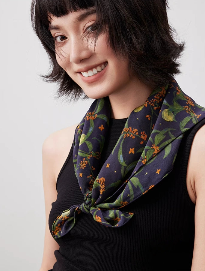 Dark blue osmanthus silk square scarf styled as a neck accessory, demonstrating its elegance and versatility.