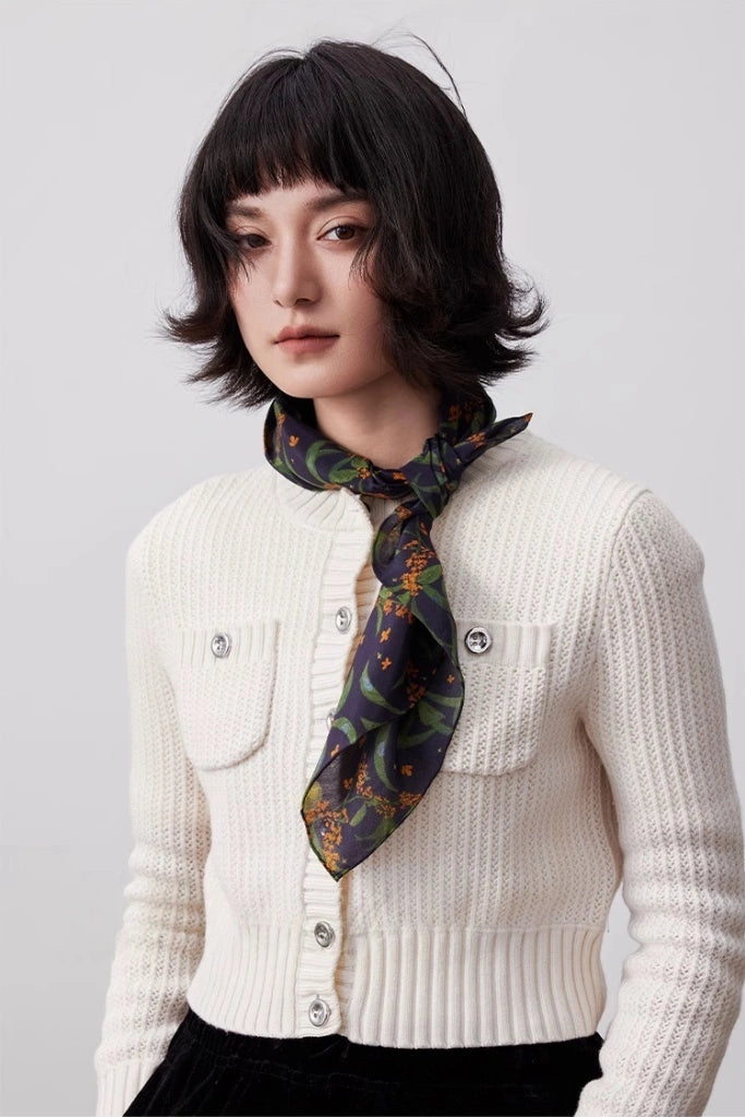 The model wears a deep blue osmanthus silk square scarf as a neck accessory, showcasing its elegance and versatility.