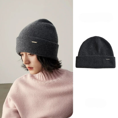 Model wearing a dark gray pure cashmere cuffed beanie with a matching product view