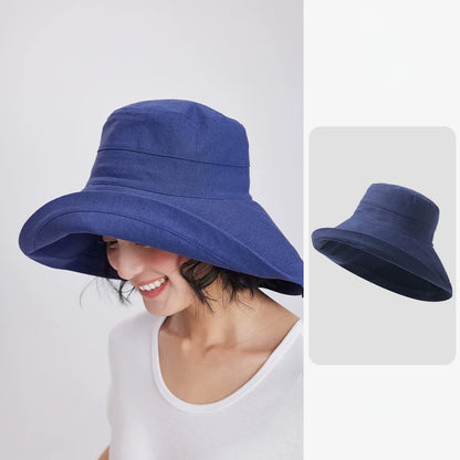 Woman wearing a deep blue linen blend wide brim sun hat with a relaxed bucket-style silhouette