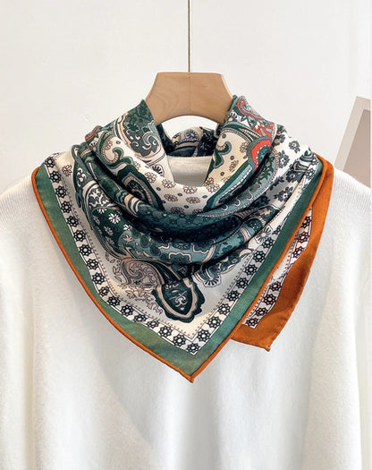 Silk wool square scarf in green paisley pattern, double-sided contrast design worn around neck