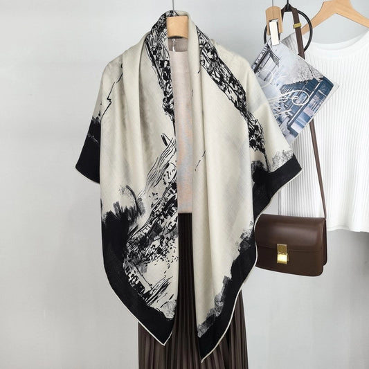 Black and ivory Eiffel Tower scarf styled as a long shoulder wrap with a handbag and neutral outfit