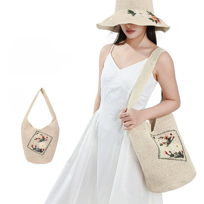 Woman carrying an ivory floral embroidered woven straw shoulder bag with matching wide brim sun hat for summer vacation outfits