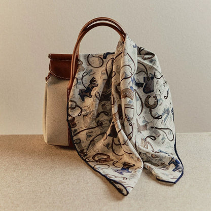 Silk wool square scarf horse tack print draped on handbag, vintage equestrian style