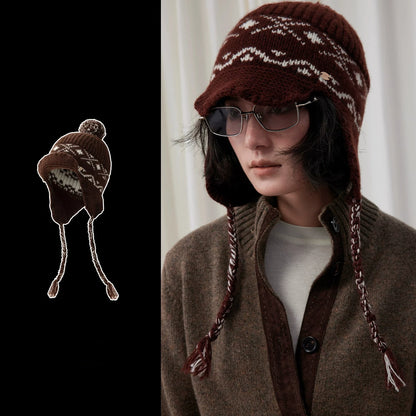Coffee brown Fair Isle wool earflap beanie with visor and braided ties, shown on a model and as a product cutout.