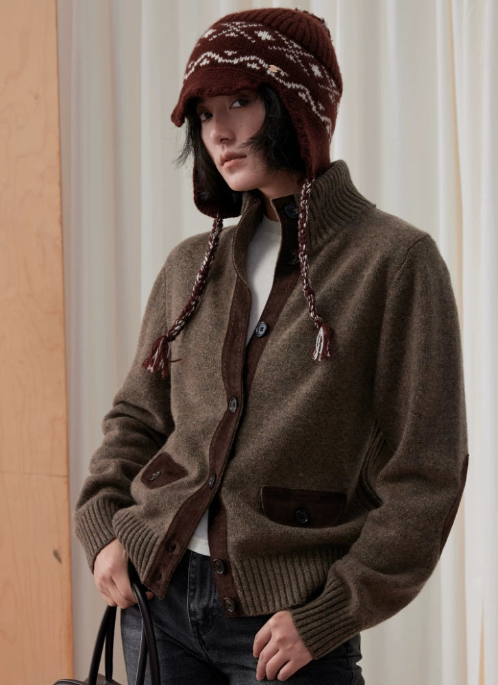 Model wearing a coffee brown Fair Isle earflap beanie with a brown cardigan and dark jeans.