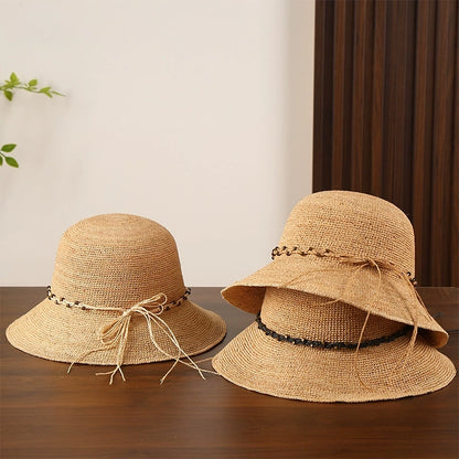 Natural raffia sun hats with bow details and wide brims, shown together for summer beach and travel styling.