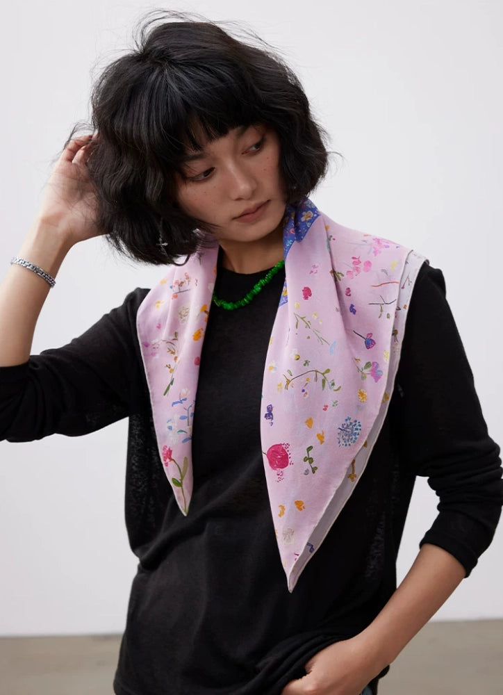Floral dolphin silk scarf styled as a luxury neck scarf with soft pink tones.
