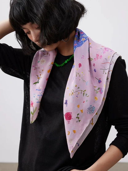 Pink botanical and dolphin silk scarf worn as an elegant draped neck scarf.