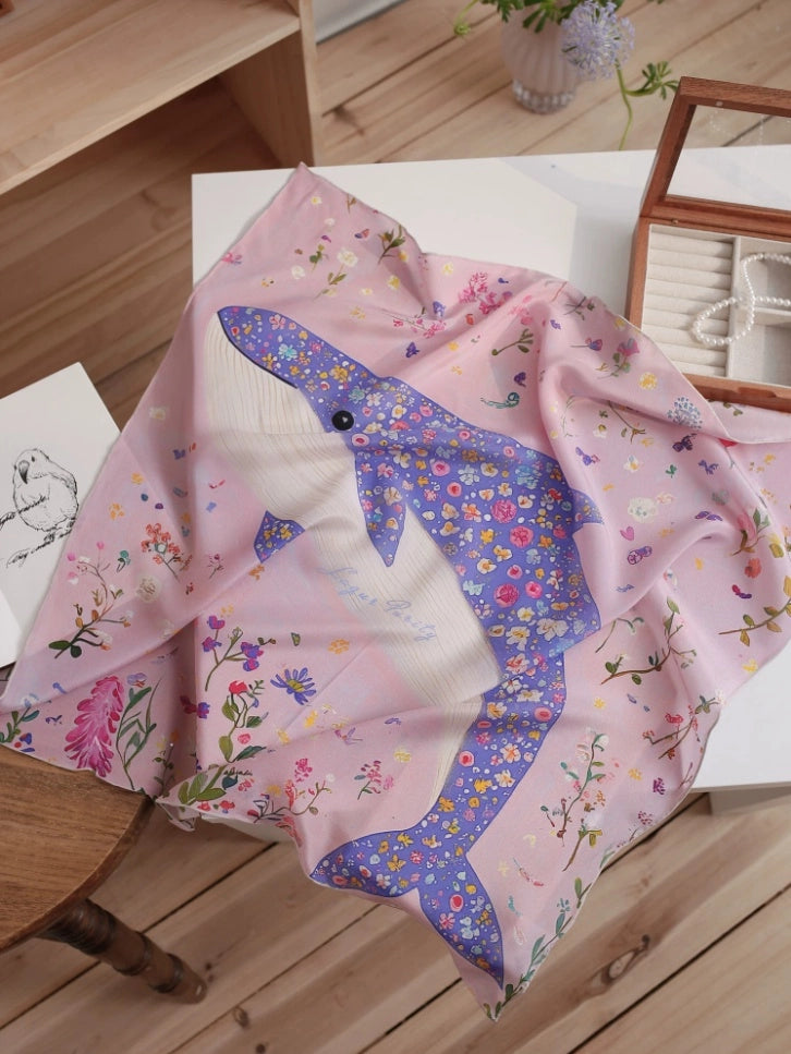 Oceanic floral silk carré with blue dolphin and pink botanical print laid flat.