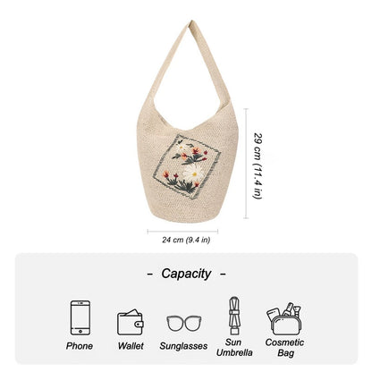 Floral embroidered straw shoulder bag showing capacity for phone wallet sunglasses sun umbrella and cosmetic bag