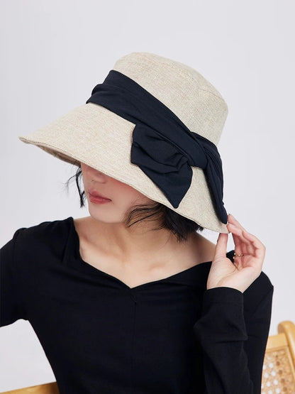 Beige bucket hat with bow and wide brim, styled for daily city wear, beach trips, and summer outdoor occasions.