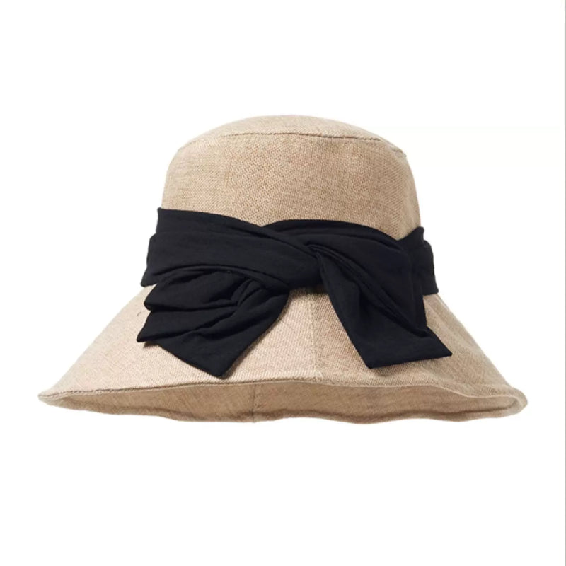 Beige foldable sun hat with black bow ribbon, breathable woven crown, and elegant wide brim for women.