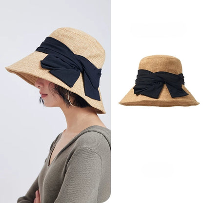 Natural flax foldable wide brim bow sun hat for women with breathable woven texture and black ribbon detail.