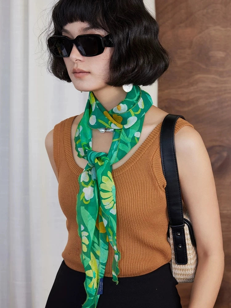 Model wearing a forest green botanical print skinny silk scarf for elegant everyday styling