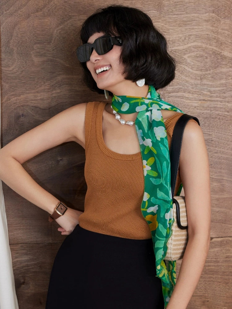 Forest green long silk scarf worn with brown sleeveless top for a refined summer look