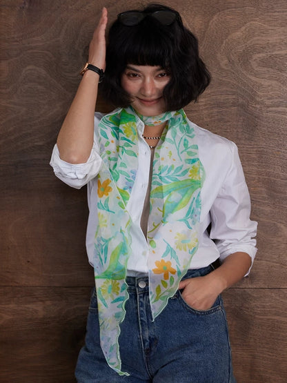 Fresh green floral skinny silk scarf tied around the neck for an elegant everyday look