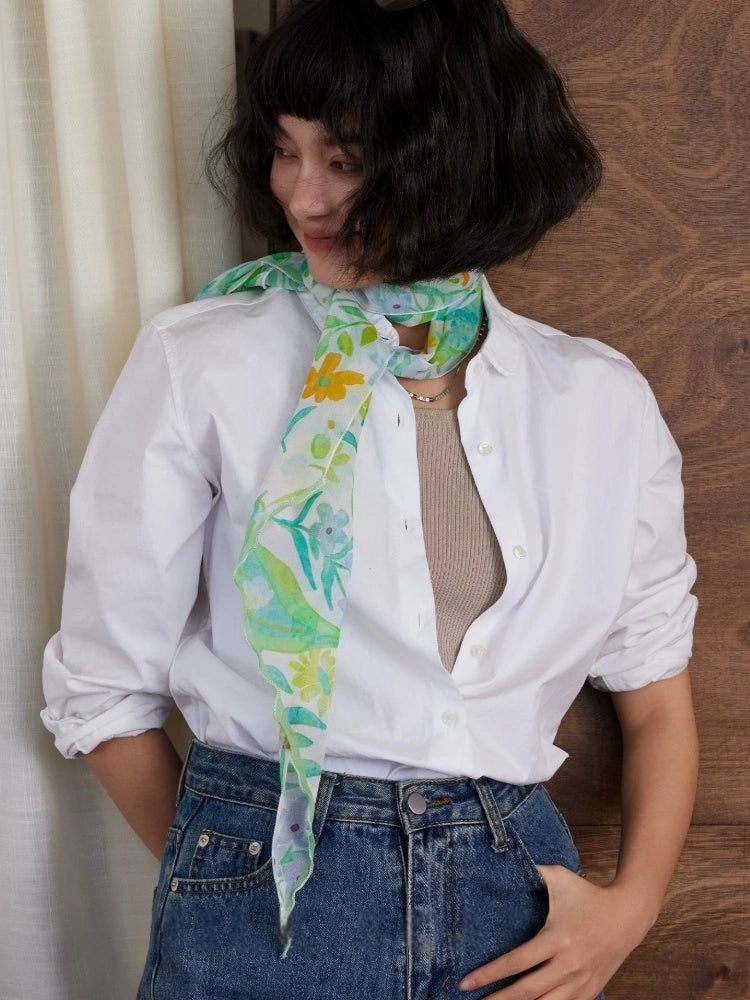 Lightweight fresh green botanical silk scarf styled with white shirt for elegant summer fashion
