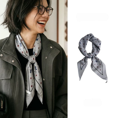 Gray ditsy floral silk wool diamond scarf styled at the neck, with product view