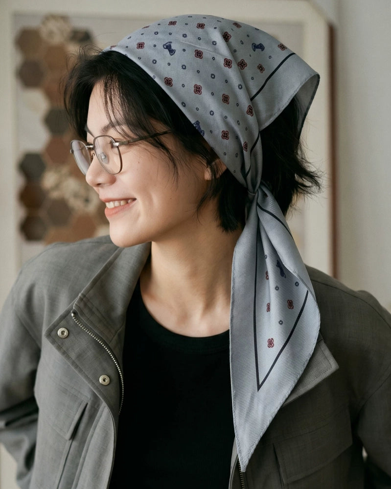Gray ditsy floral silk wool scarf styled as a vintage headscarf with long pointed ends