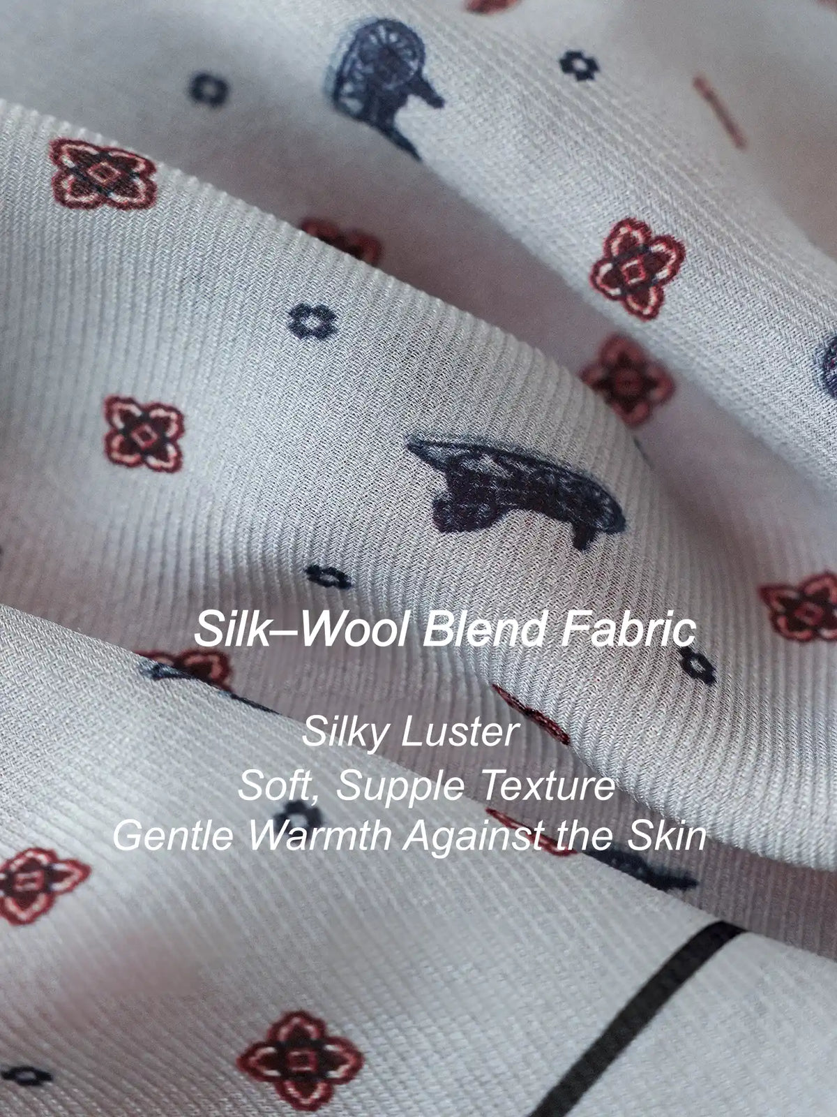 Close-up of gray silk wool fabric with burgundy and navy ditsy floral motifs