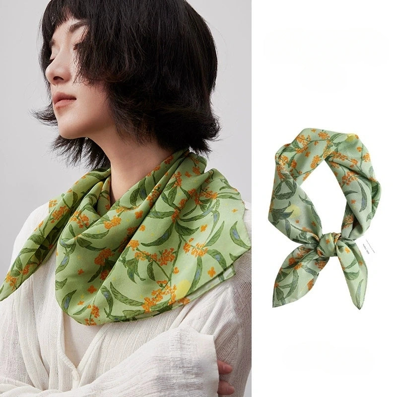 Elegant green osmanthus print silk square scarf, made from 100% mulberry silk, showcases its vibrant floral design and smooth texture.