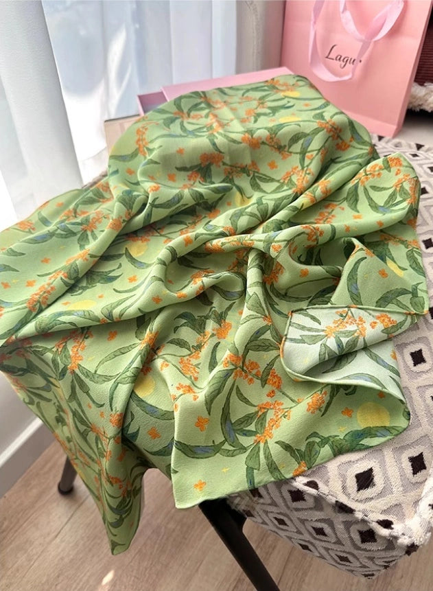 Green osmanthus floral silk square scarf, 100% mulberry silk, displayed flat to highlight its vibrant floral design.
