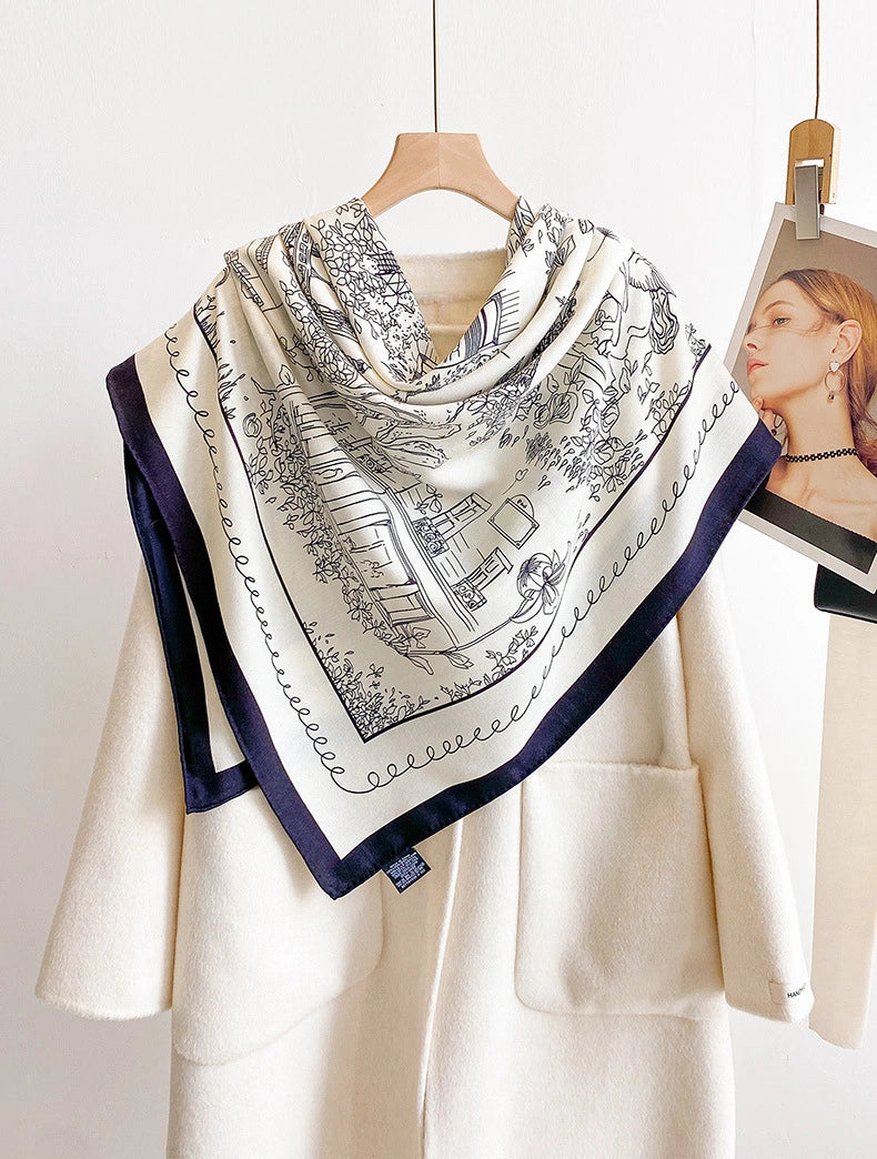 Ivory architectural print silk wool square scarf styled as a triangular shoulder wrap