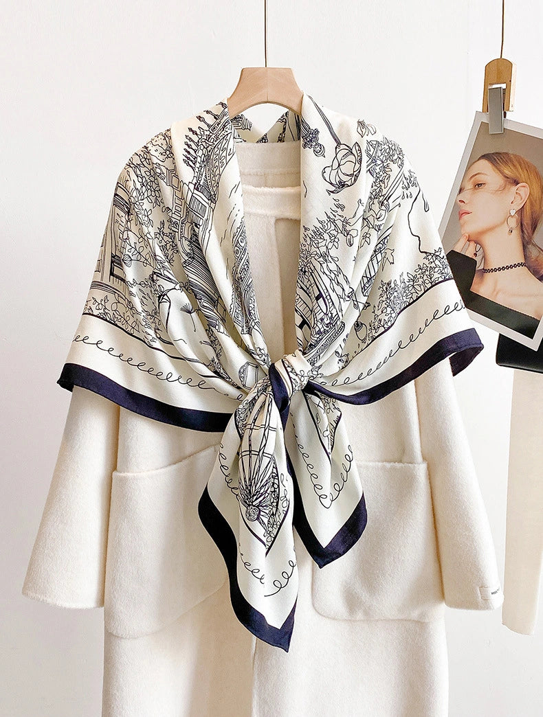 Ivory streetscape silk wool scarf tied at the front over a minimalist white outfit