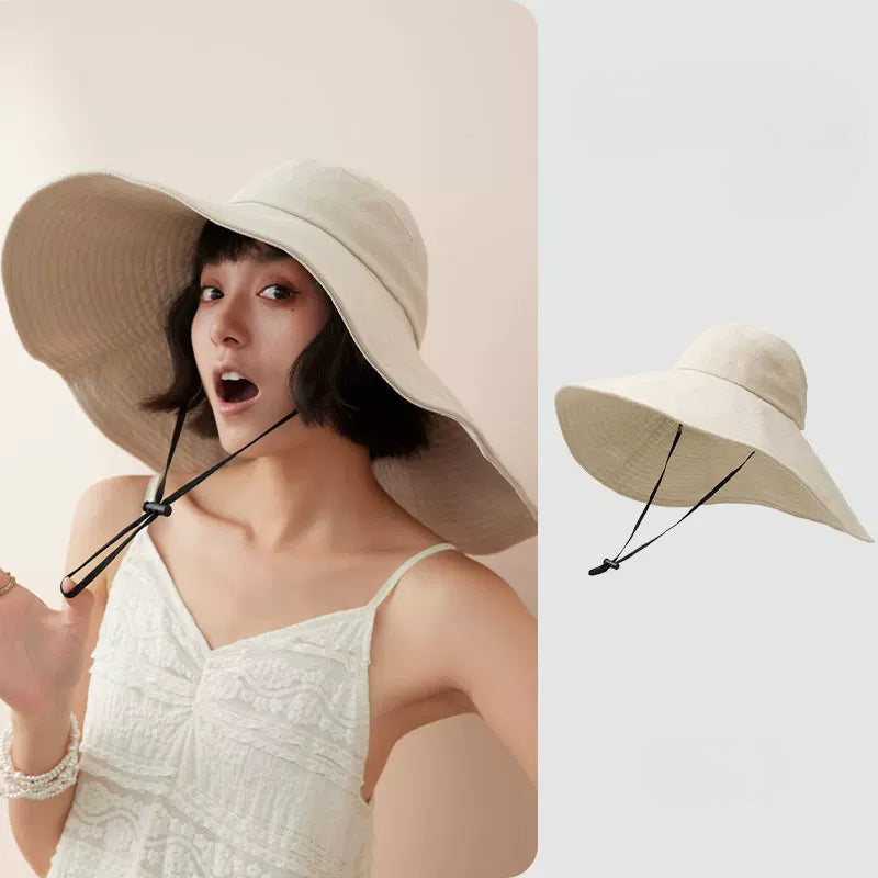 Woman wearing ivory cotton oversized wide brim sun hat with wind cord, shown with product view