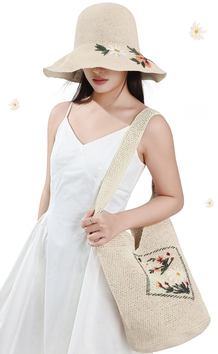Ivory straw hat and matching floral embroidered shoulder bag styled with a white vacation dress