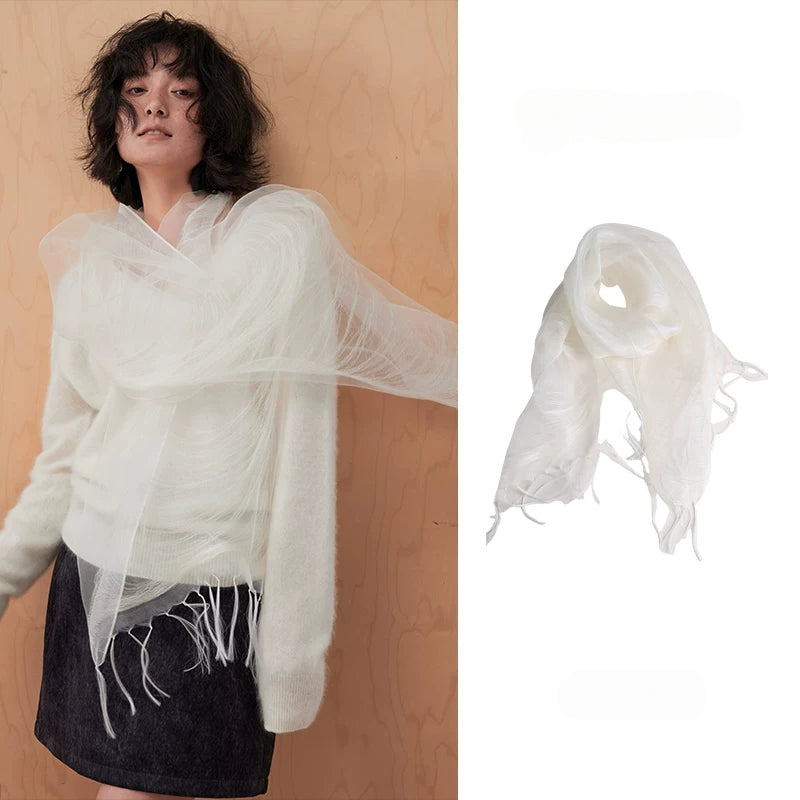 Woman wearing an ivory white sheer mulberry silk fringe scarf over a cream sweater
