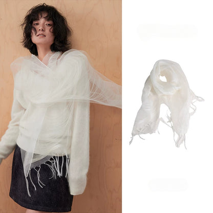 Woman wearing an ivory white sheer mulberry silk fringe scarf over a cream sweater