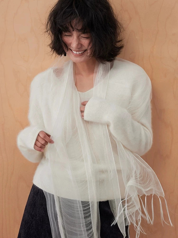 Ivory white lightweight silk wrap draped around the shoulders with delicate fringe