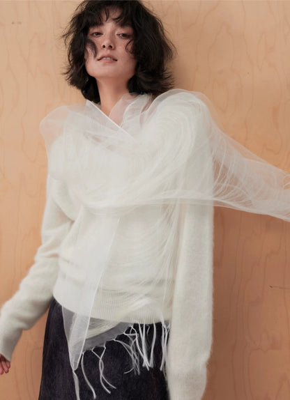 Woman styling a sheer ivory mulberry silk scarf as an elegant shoulder cover-up
