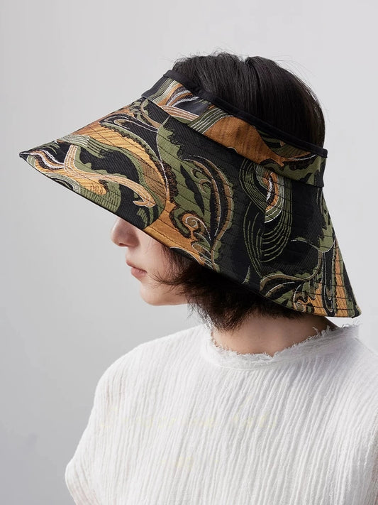 Side view of antique olive jacquard wide brim sun visor hat for women with vintage woven pattern.