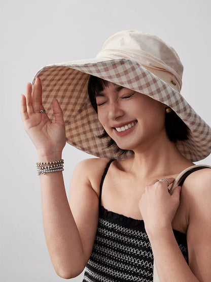 Woman styling khaki cotton wide brim sun hat with plaid lining for summer outdoor wear