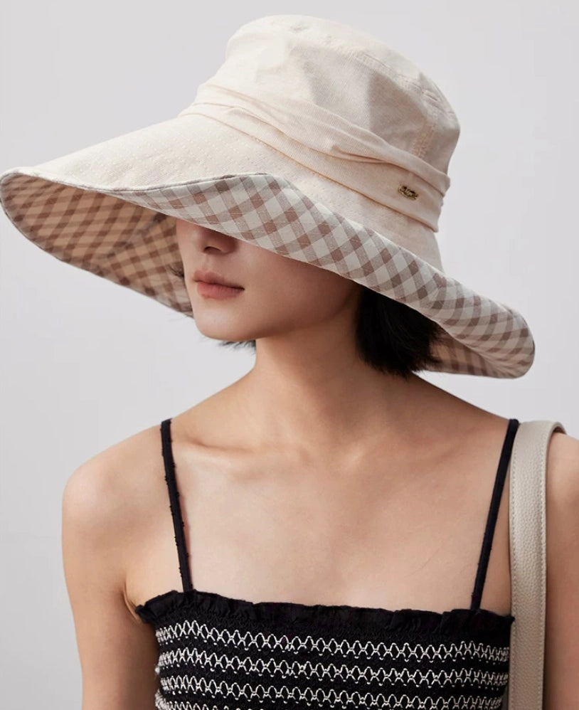 Side view of khaki cotton floppy sun hat with oversized brim and gingham plaid lining