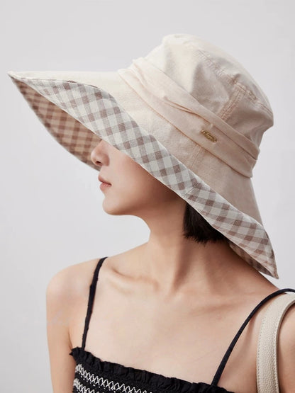 Woman wearing khaki plaid lining sun hat with wide brim for beach, garden, and travel