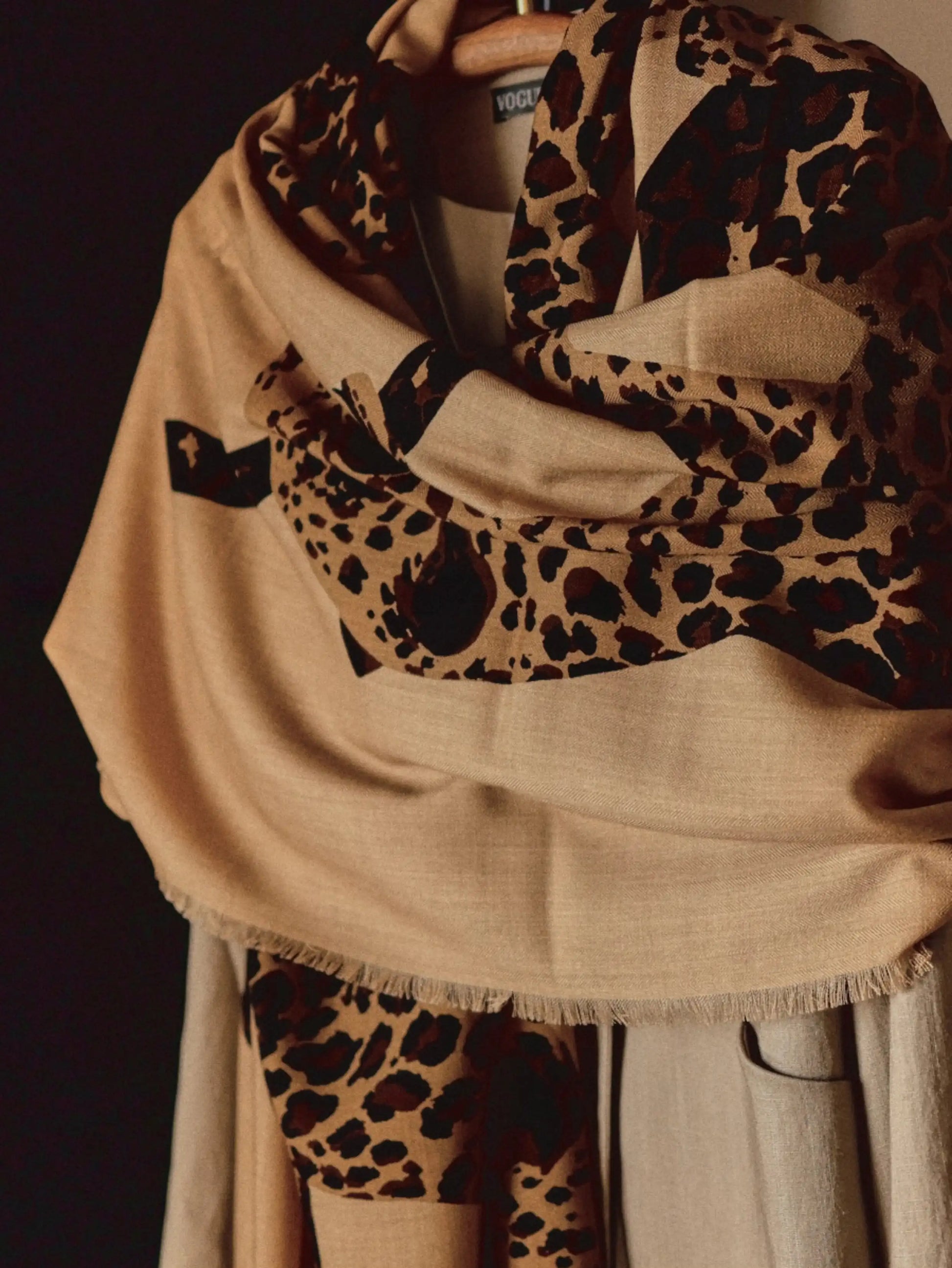 Oversized khaki leopard graphic wool shawl styled as an elegant wrap with a beige outfit