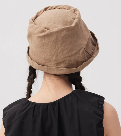 Back view of khaki crinkled linen bucket hat with hand-textured crown and foldable shape