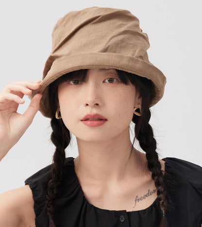 Front view of khaki crinkled linen bucket hat with short brim and adjustable relaxed fit