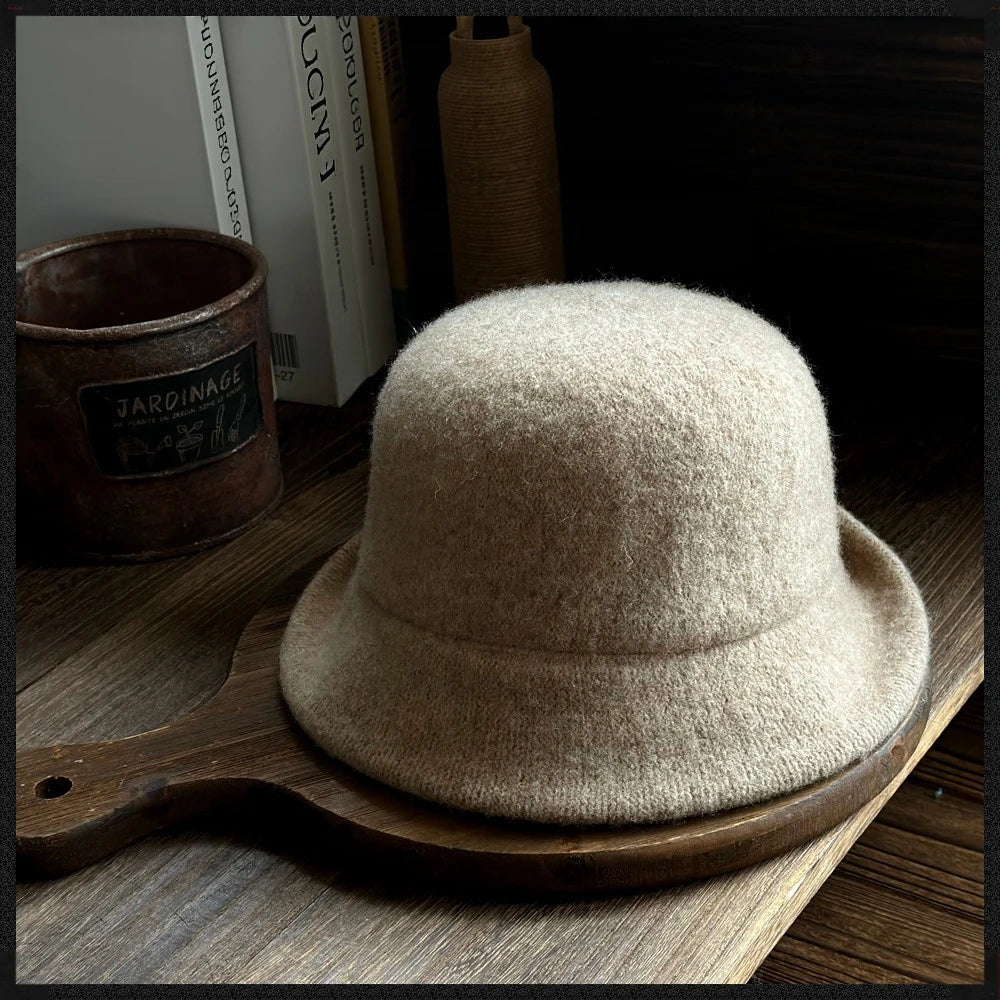 Rear view of a khaki wool felt cloche hat showing its soft dome crown and rolled brim