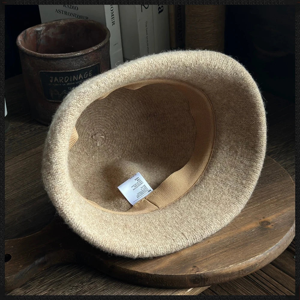 Interior view of a khaki wool felt cloche hat showing the crown, inner band and rolled brim