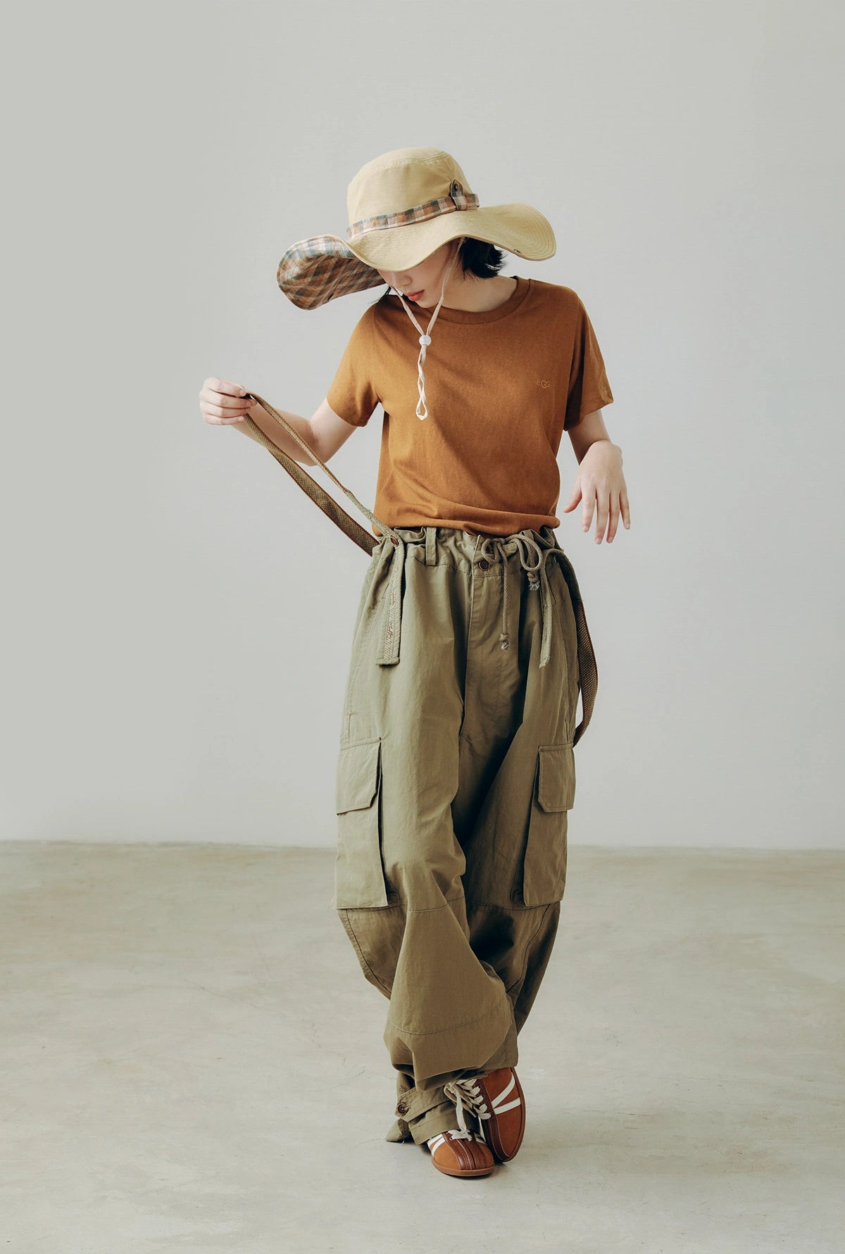 Foldable khaki wide brim sun hat with chin string, styled for hiking, camping, and summer travel.