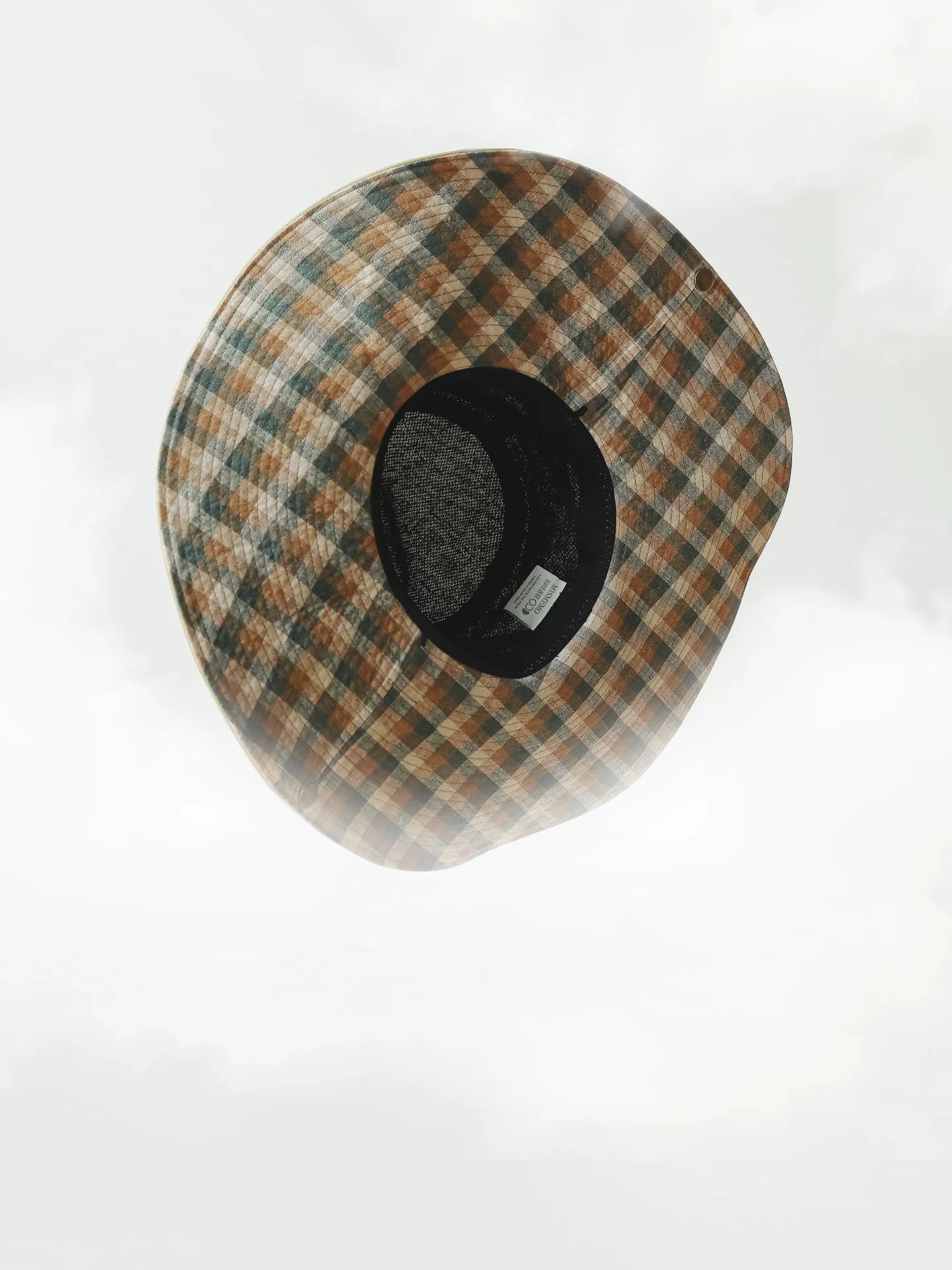 Top view of plaid wide brim outdoor sun hat with adjustable inner band and breathable linen texture.