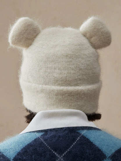 Back view of a cream white koala ear knit beanie showing two rounded ears.