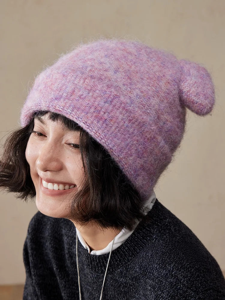Smiling woman wearing a misty lavender koala ear knit beanie.
