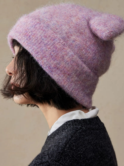 Side view of a misty lavender koala ear knit beanie showing a rounded ear and fuzzy texture.
